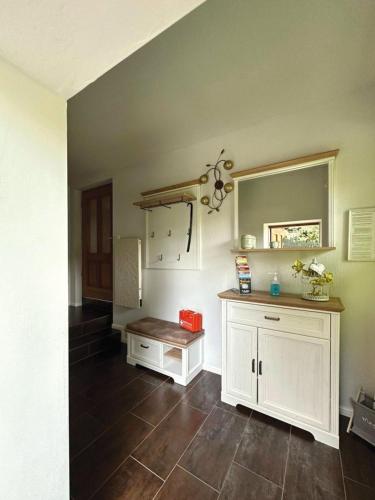 a kitchen with white cabinets and a tile floor at Nicole in Quedlinburg
