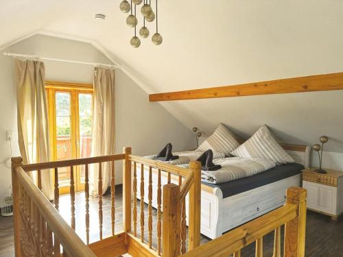 a bedroom with a bed and a wooden staircase at Nicole in Quedlinburg