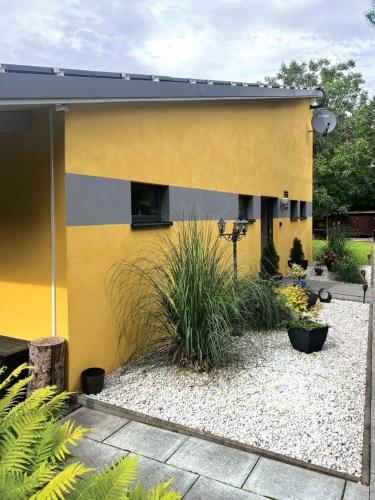 a yellow building with plants in front of it at Nicole II in Quedlinburg