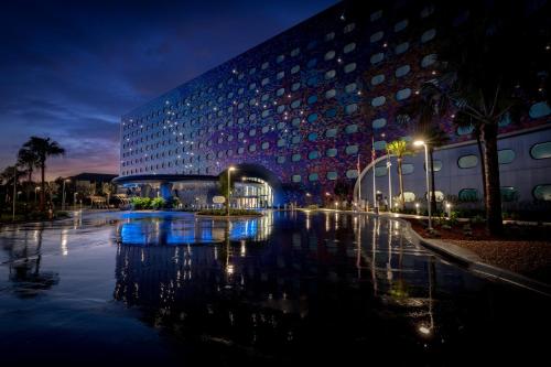 a large building with a bridge in front of it at Universal's Stella Nova Resort in Orlando