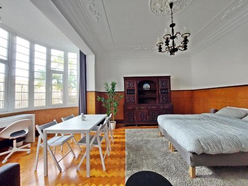 a bedroom with a bed and a table and chairs at Don Alvares in Lisbon
