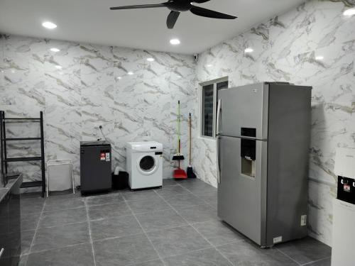 a kitchen with a refrigerator and a washing machine at KLANG - Enjoy Life Klang Homestay in Klang