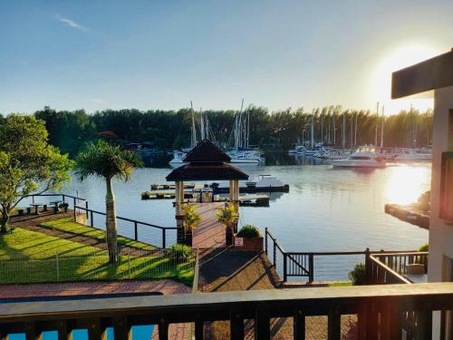 a view of a marina with boats in the water at Mzingazi Waterfront Accommodation, On The Bay Waterfront Villa's in Richards Bay
