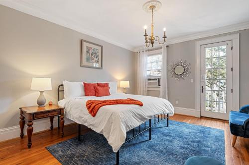 a bedroom with a bed with a blue rug at Sleeps 16! Walk To Broughton And River Street!-1-3 in Savannah