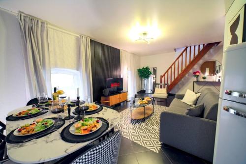 - un salon avec deux assiettes de nourriture sur une table dans l'établissement Superbe appartement contemporain Mulhouse Centre, à Mulhouse