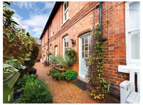 a brick building with plants on the side of it at Jasmine Cottage in Chester