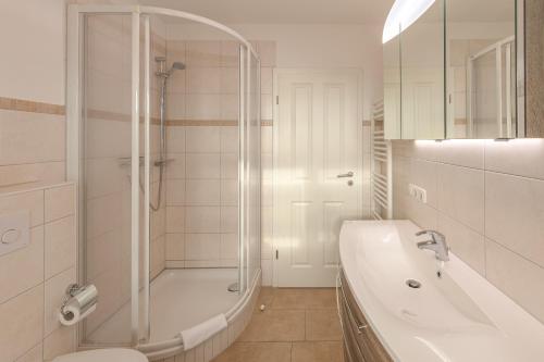 a bathroom with a shower and a toilet and a sink at Kapitänsdeck 534 in Rechlin