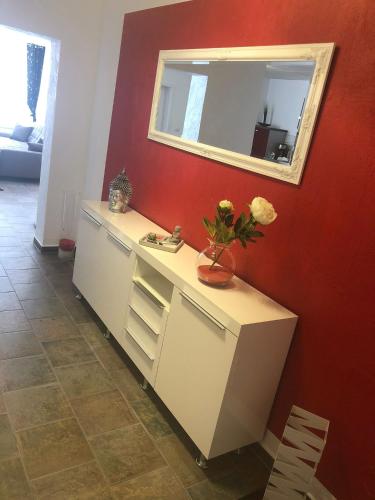 a bathroom with a white vanity with a mirror at Müritz Apartments in Waren