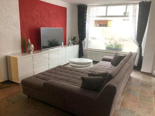 a living room with a couch and a window at Müritz Apartments in Waren