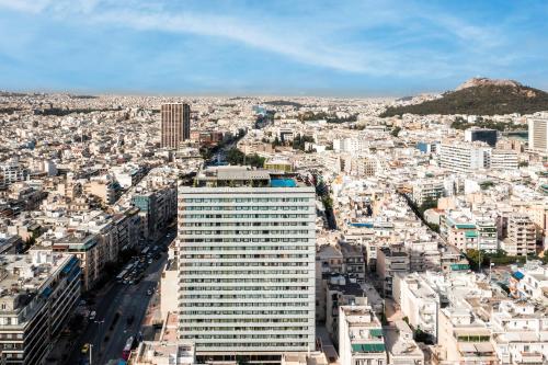 a view of a city with a tall building at President Hotel Athens in Athens