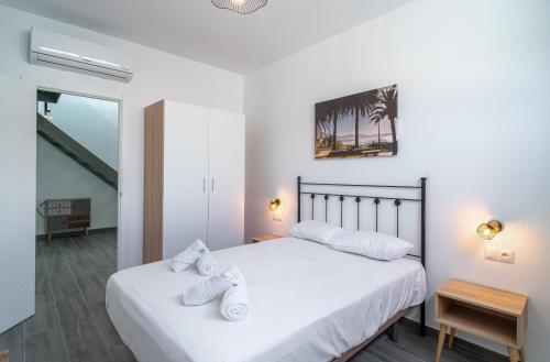a bedroom with two beds with white sheets at Villa Mauri Private Pool by Casasol in Nerja