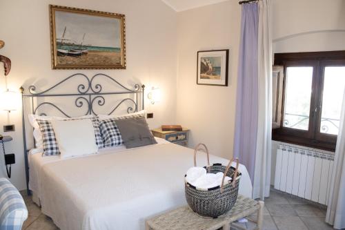 a bedroom with a bed with a basket on it at Boutique Hotel Fox's Inn in San Giustino Valdarno