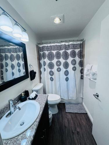 a bathroom with a sink and a toilet and a shower at Amazing Universal Studios Loft FREE parking in Los Angeles