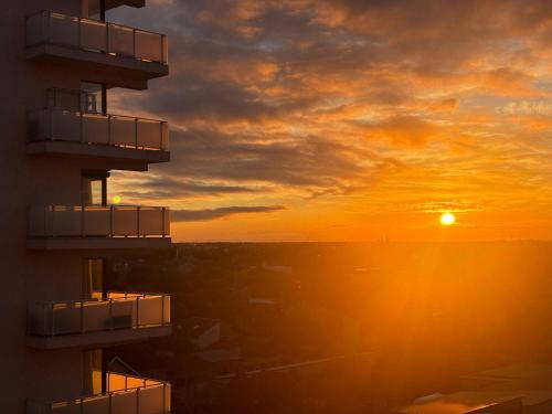 a sunset from the balcony of a building at Adam Residence in Oradea