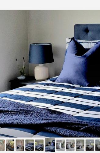 a bedroom with a bed with a blue and white comforter at Kennedy House Euroa PERFECT FOR SHORT TERM STAYS in Euroa