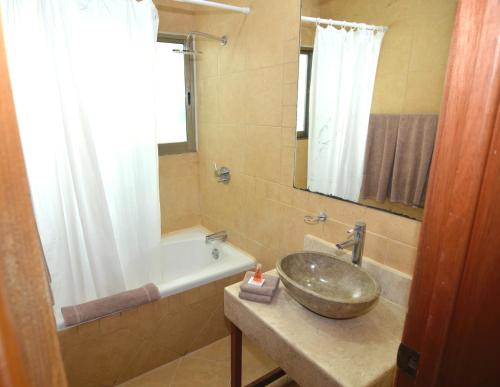 a bathroom with a sink and a tub at Rinconada del Mar APTS in Playa del Carmen