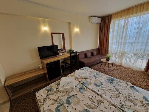 a hotel room with a bed and a television at Family Hotel Diana in Tsarevo