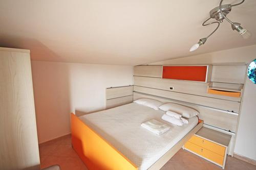 a small bedroom with a bed in a room at Soffio di mare in Alba Adriatica