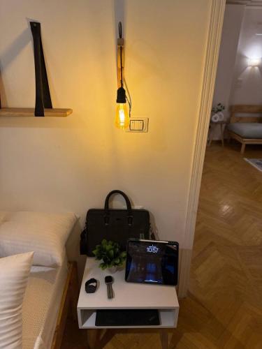 a bed with a table with a laptop on it at Luxury Lodge for Men in Cairo