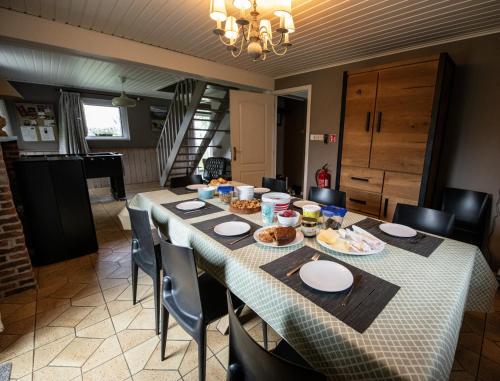 a dining room with a table with food on it at Ô Macra House - Aubel, Pays de Herve in Aubel