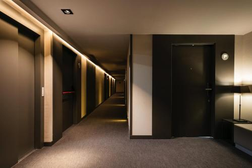 a hallway with black walls and a hallway with lights at Upper Diagonal in Barcelona
