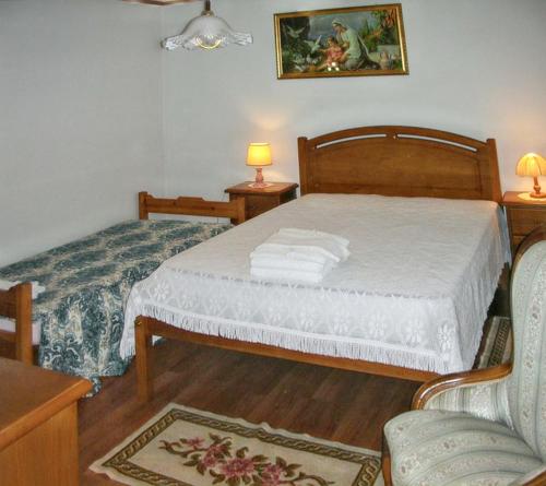 a small bedroom with a bed and a chair at Charming villa with mountain view in Pedraça, pool in Pedraça