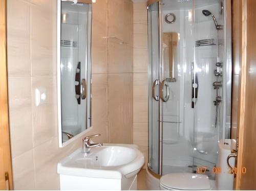 a bathroom with a sink and a shower and a toilet at Charming villa with mountain view in Pedraça, pool in Pedraça