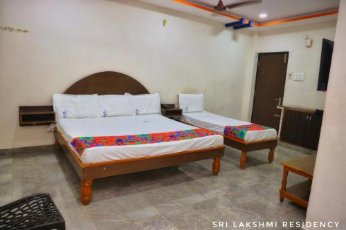 a bedroom with two beds in a room at Sri Lakshmi Residency in Tirupati