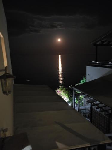 a view of the moon from the roof of a house at night at Ilaira Beach Apartments in Chrani