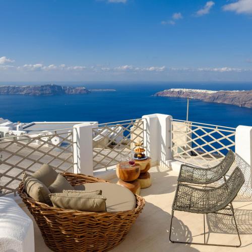 a balcony with chairs and a view of the ocean at Nastazia Residence in Imerovigli