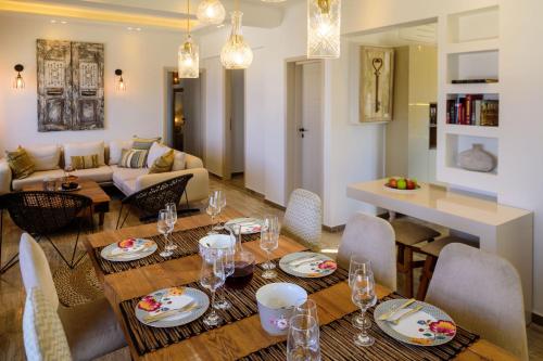 a dining room and living room with a table and chairs at Nastazia Residence in Imerovigli