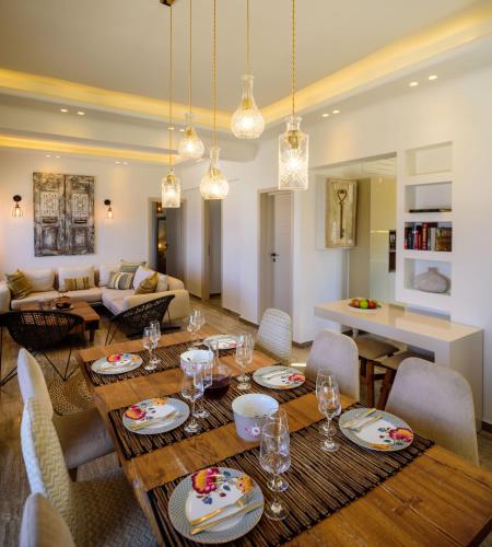 a dining room and living room with a table and chairs at Nastazia Residence in Imerovigli