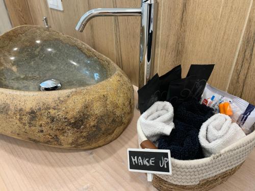 a large stone sink sitting on top of a bathroom counter at IL COMO' DELLA CIVETTA - Nido del Picchio in Villa di Tirano