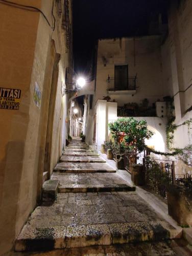 an empty alley at night in an old town at Kryptàdion in Grottaglie