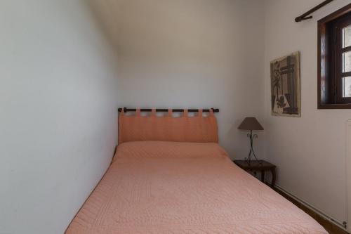 a bed in a bedroom with a orange bedspread at La Renardière Provence in Mollans-sur-Ouvèze