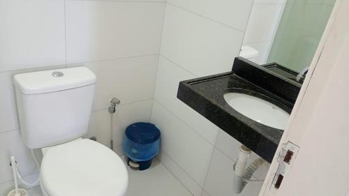 a bathroom with a white toilet and a sink at Apartamento Arcoverde 02 in Arcoverde
