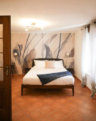 a bedroom with a bed with a painting on the wall at Clos du Pinot by Hili in Aosta