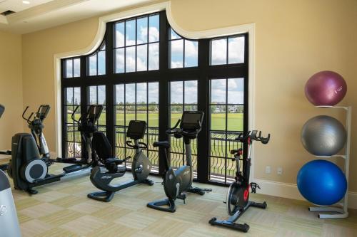 a gym with exercise equipment and a large window at Beautiful House with Pool in Reunion Orlando 10 minutes from Disney in Orlando