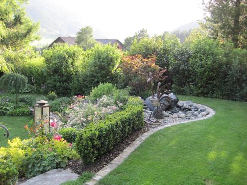 a garden with a train in the middle of a yard at Gästehaus Schneeberger in Matrei in Osttirol