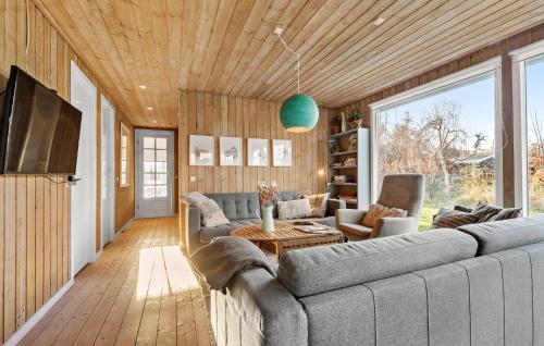 a living room with a couch and a tv at Awesome Home In Ebeltoft With Sauna in Ebeltoft