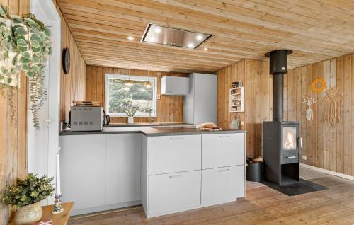 a kitchen with white cabinets and a stove at Awesome Home In Ebeltoft With Sauna in Ebeltoft