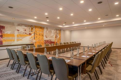 a large conference room with a long table and chairs at Munich Marriott Hotel in Munich