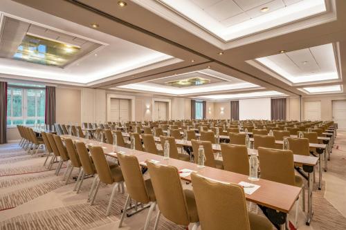 a large room with rows of tables and chairs at Munich Marriott Hotel in Munich