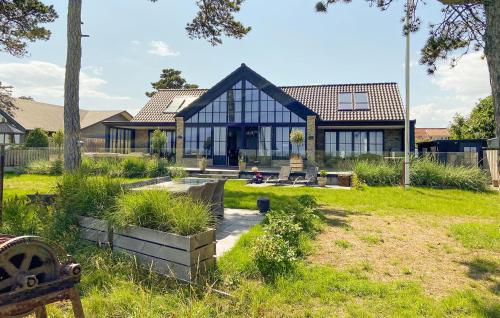 a large house with glass windows on a yard at Nice Home In Odder With House Sea View in Odder