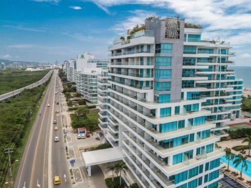 a tall building with a sign on the side of a road at Emmaus in Cartagena de Indias