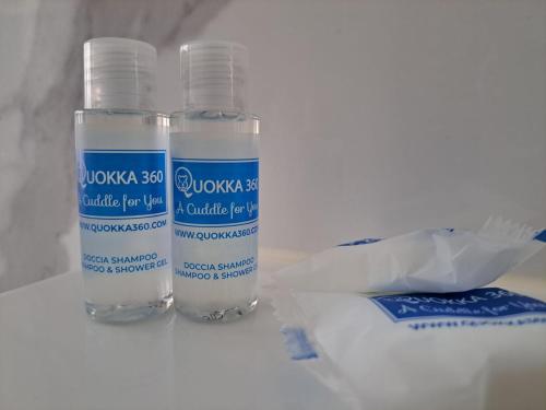 two bottles of water sitting on a table at Urban Residence by Quokka 360 - Apartments with parking in Lugano in Aldesago