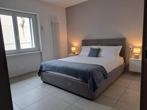 a bedroom with a large bed and a window at Urban Residence by Quokka 360 - Apartments with parking in Lugano in Aldesago