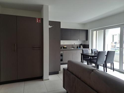 a living room with a couch and a table with chairs at Urban Residence by Quokka 360 - Apartments with parking in Lugano in Aldesago