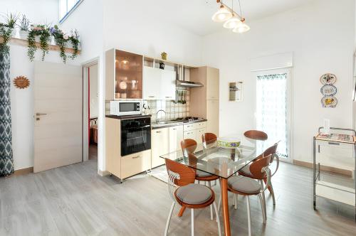 a kitchen with a glass table and chairs in a room at Elegant Villa with Private Pool in Alcamo Marina – Sea View in Alcamo Marina