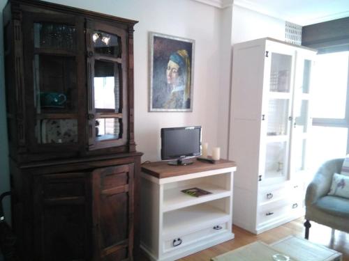 a living room with a dresser with a tv and a cabinet at Miguelete in Selaya